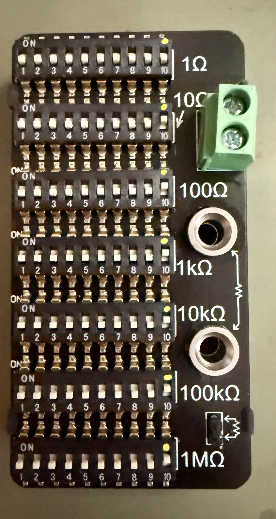 A resistance decade box: rows of switches for 1 ohm to 1 megohm.