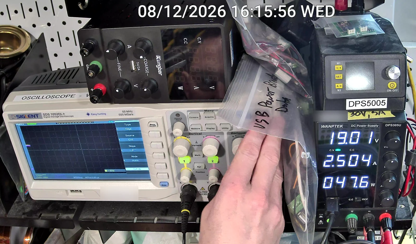The bench supply at the moment of the protection trip, reading 19.01 volts, 2.504 amps, 47.6 watts, with the oscilloscope beside it.