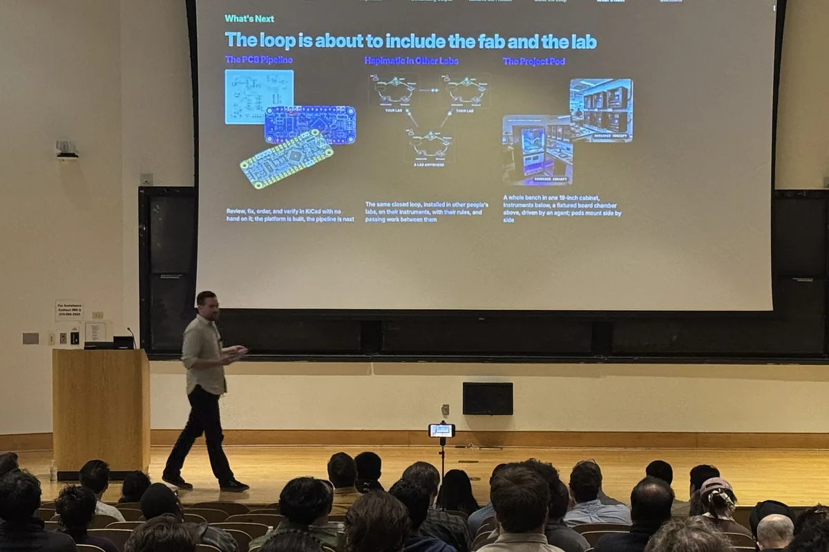 The audience watching Matt Starfield present the slide on bringing the loop to the fab and the lab